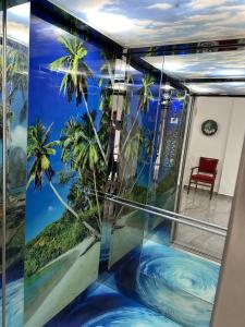 a room with a palm tree mural on the wall at Sea La Vie in Shëngjin +291 photos