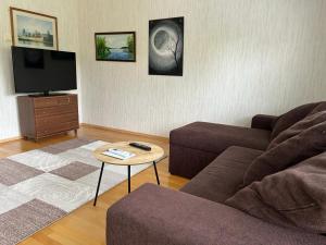 a living room with a couch and a coffee table at Rivitalokaksio *Autokatospaikka* in Seinäjoki