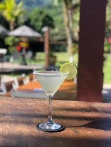 a margarita with a lime in a glass on a table at Delta Maresias Studio in São Sebastião