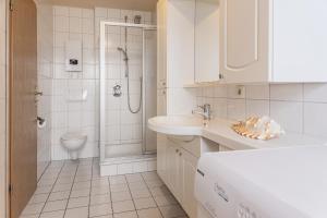 bagno bianco con lavandino e servizi igienici di 50178... a Harlesiel