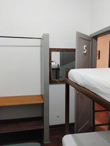 a bedroom with a bunk bed and a mirror at Pousada Seu Souza in Belo Horizonte