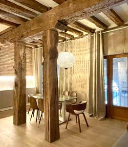 a dining room with a table and chairs at Lauramer Plaza Nueva in Bilbao +10 photos