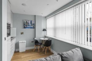 a living room with a couch and a table at Luxurious One Bedroom Apartment in Bond Street in Chelmsford