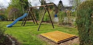 a playground with a ladder and a slide at Ferienhaus Sturmtaucher in Otterndorf