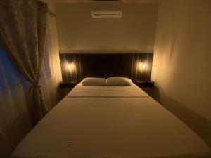 Ένα ή περισσότερα κρεβάτια σε δωμάτιο στο HOTEL EBENEZER