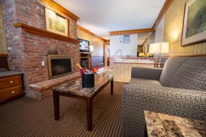 a living room with a couch and a fireplace at Best Western Fireside Inn in Kingston