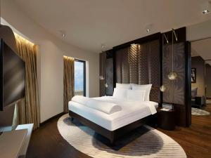 a bedroom with a large bed and a large window at Pullman New Delhi Aerocity- International Airport in New Delhi