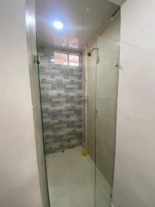 a bathroom with a shower with a glass door at Apartamento con hermosa vista 502 in Ibagué