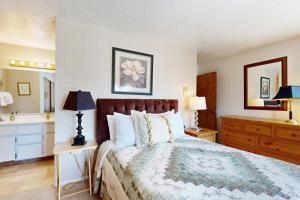 a bedroom with a large bed and a sink at Katherine Court Townhouse in Stateline