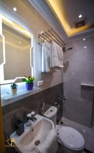 a bathroom with a white toilet and a sink at tourist hotels cairo downtown in Cairo