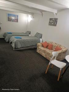 a bedroom with a bed and a couch at The Cave Motel in Levin