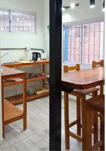 a kitchen with a wooden table and some windows at Apartamento Julio Cesar I in Godoy Cruz