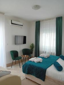 a bedroom with a bed and a table and chairs at Wing Nina2 in Jagodina