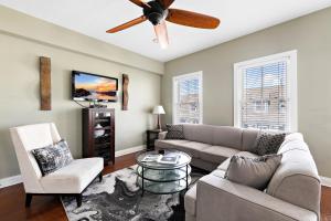 a living room with a couch and a ceiling fan at Majestic Hotel in Ocean Grove