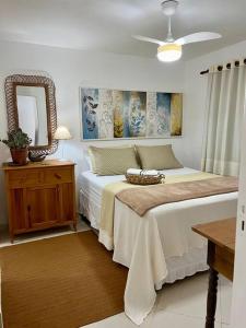 a bedroom with two beds and a mirror at Suíte Girassol Cama & Café - Centro, Marechal Floriano-ES in Marechal Floriano