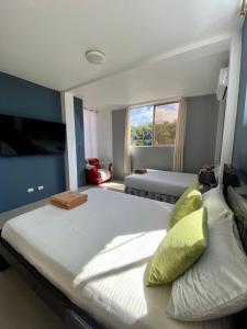 um quarto grande com 2 camas e uma janela em Suite “Raya” em Puerto Ayora