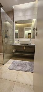 Un baño con bañera, lavabo y espejo. en Serenity - Breathtaking Views, en Nairobi 26 fotos más