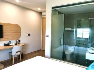 a bathroom with a glass shower and a toilet at Milash Boutique Hotel in Ha Long +55 photos