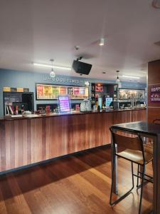 a bar in a restaurant with a table at Based by the Lake in Taupo
