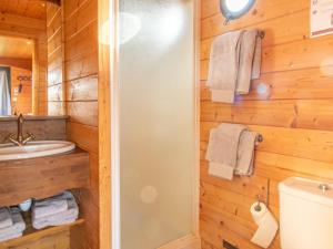 a bathroom with a shower and a toilet and a sink at Roulotte climatisée avec piscine et jardin - FR-1-622-54 in Vihiers +14 photos