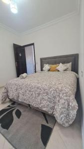 a bedroom with a large bed with pillows on it at Tadrart house - Joli Appartement à Agadir in Agadir +22 photos