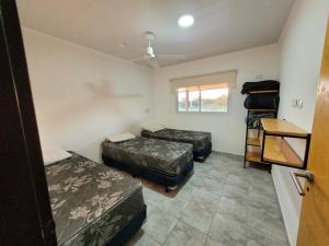 a room with two beds and a window at Ikigai in Concepción del Uruguay