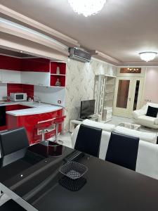 a living room with red and white furniture and a table at AMY'S LUXURY APPARTMENT in Shkodër