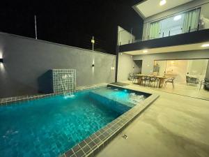 a swimming pool in the middle of a house at Casa Sofia Milagres - 200 m da Praia in São Miguel dos Milagres
