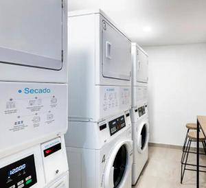 Un lavadero con una pila de lavadoras y secadoras en SecreT Top 85, en Bogotá