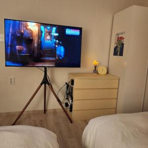 a flat screen tv on a stand in a bedroom at Stay Banwoldang in Daegu +42 photos