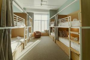 a room with three bunk beds and a window at Drifter Christchurch in Christchurch +90 photos