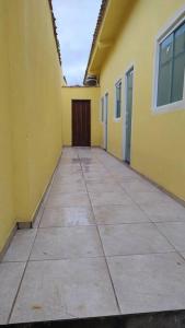 an empty hallway of a yellow building with a door at Loft Outono Centro Histórico in Paraty