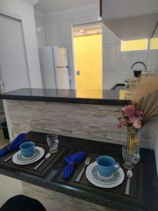 a kitchen counter with two cups and saucers on it at Loft Outono Centro Histórico in Paraty +33 photos