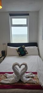 a bed with a swan made to look like a heart at North Ocean Hotel in Blackpool