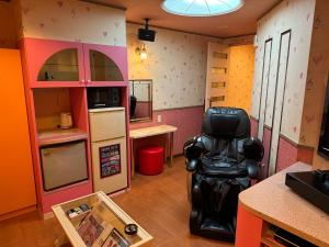 a room with a chair in the middle of a kitchen at Himeji Baby Kiss (Adult Only) in Himeji