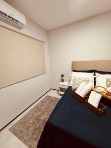 a bedroom with a bed and a large screen at Studio 208 Praia de Iracema in Fortaleza