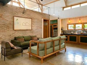 a living room with a couch and a chair at Iron Rose Villa with garden & pool Kuta Lombok in Kuta Lombok