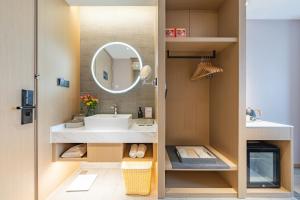 a bathroom with a sink and a mirror at Atour Hotel Shanghai New International Expo Center South Yanggao Road in Shanghai +28 photos