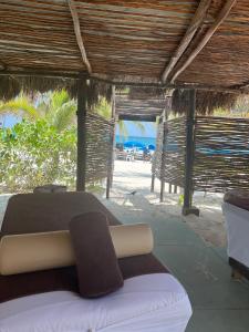 a bed in a resort with a view of the beach at El Paraiso Hotel Tulum in Tulum