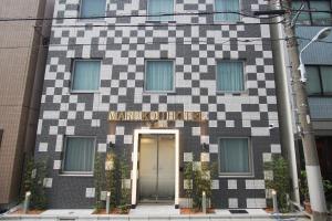 a building with a checkerboard pattern on it at MARUKOU HOTEL in Tokyo