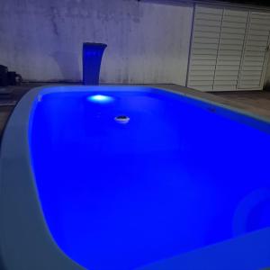 a blue bath tub with a blue vase in a room at Casa de praia in Sirinhaém +3 photos