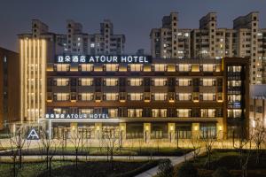 a hotel with a sign that reads take a tour hotel at Atour Hotel Shanghai New International Expo Center South Yanggao Road in Shanghai