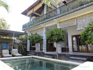 a house with a swimming pool in front of it at Blue Royal Amed in Amed