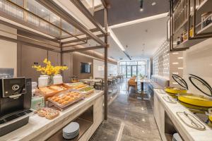 a large kitchen with a lot of food on display at Atour Hotel Shanghai New International Expo Center South Yanggao Road in Shanghai