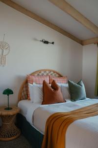 a bedroom with a bed with pillows on it at The PC Cottage in Port Campbell