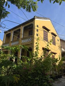 a yellow building with words on the side of it at Pao Homes - Riverside House in Hoi An