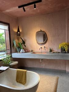 a bathroom with a large sink and a mirror at Pao Homes - Riverside House in Hoi An
