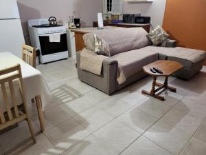 a living room with a couch and a kitchen at Birdie's Nest in Black Rock