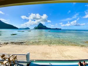 a view of a beach with boats in the water at The Nest El Nido Beach Resort in El Nido