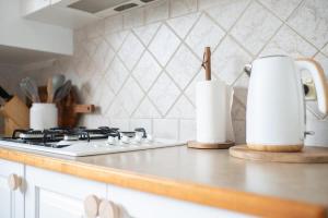 a kitchen with a stove and a counter top at Villa 88 - Stylish, Modern, Fresh & Light in Orange